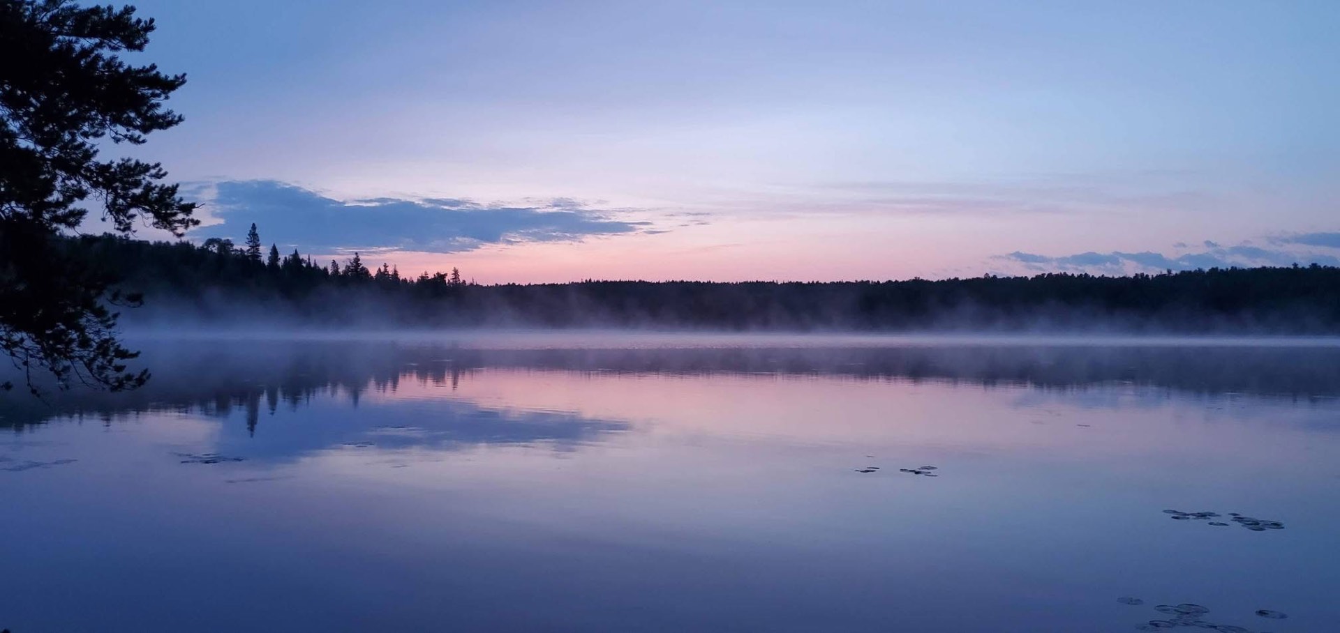 Mist over a quiet Wisconsin river at dawn